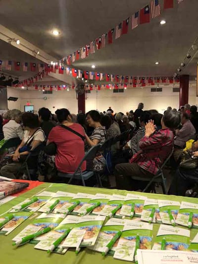 Crowd of residents seated in an event hall.