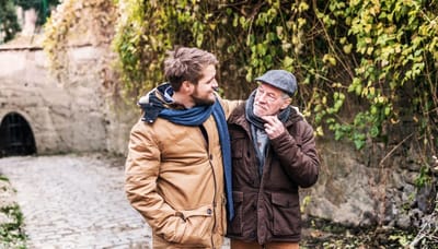 Two men talking in an outdoor setting.