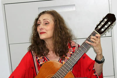 Woman playing guitar in a vibrant room