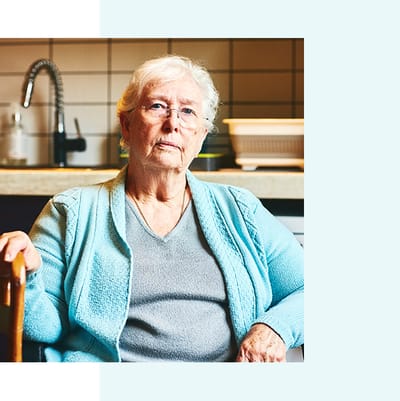 Senior woman seated in a cozy indoor setting