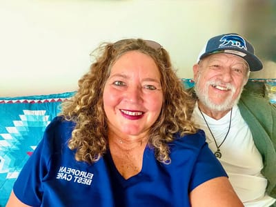 Smiling staff member with a resident indoors