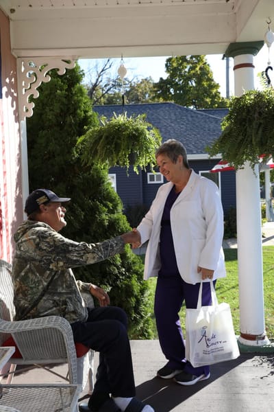 Staff member greeting a resident outside