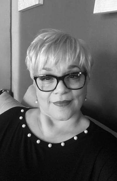 Portrait of a smiling woman with glasses