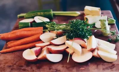 Chopped vegetables on a wooden cutting board.