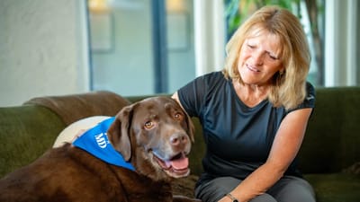 Resident enjoying time with a therapy dog.