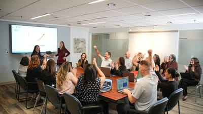 Staff celebrating in a conference room meeting