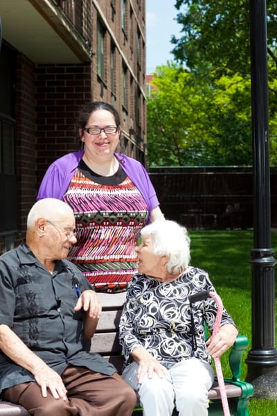 Residents and staff enjoying time outdoors in a courtyard