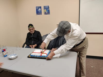 Residents celebrating with a cake during an event