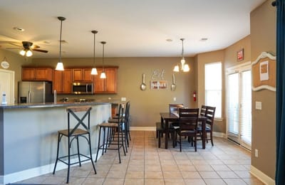 Bright dining room area with seating and kitchen