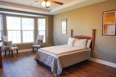 A well-furnished bedroom in a senior living facility