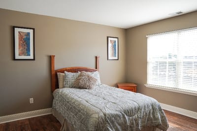 Cozy private room with a bed and wall decor