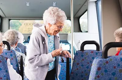 Elderly residents interacting on a facility transport van.