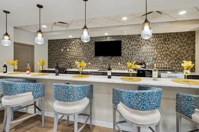 Stylish bar area with green accents and decorative lighting