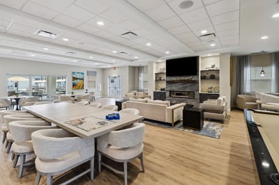 Bright common area with seating and a fireplace.