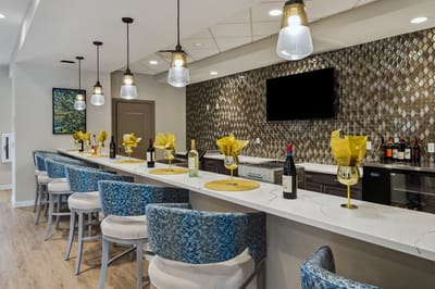 Modern bar area with stylish seating and decor.