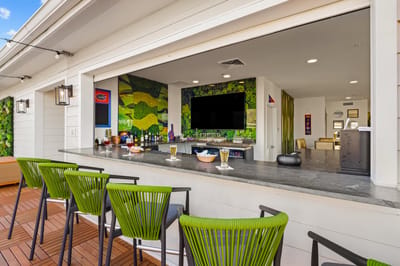 Outdoor bar area with seating and greenery.