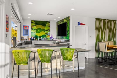 Bright interior bar area with green chairs