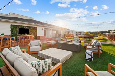 Outdoor lounge area with seating and greenery.