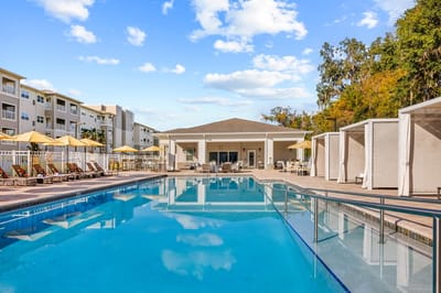 Outdoor pool area with seating and umbrellas