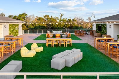 Outdoor lounge area with seating and greenery.