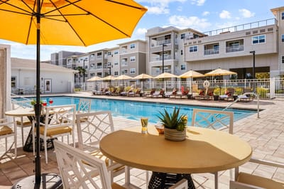Pool area with chairs and umbrellas