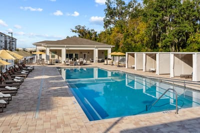 Outdoor pool area with lounge chairs and cabanas