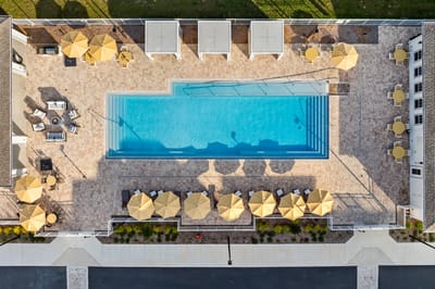 Aerial view of the facility pool area with umbrellas.