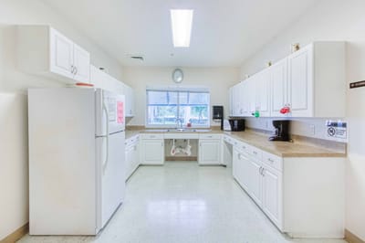 Bright kitchen area with white cabinets