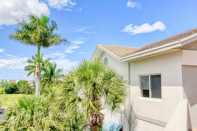 Exterior view featuring palm trees and building