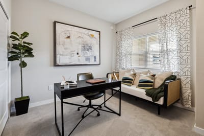 A modern interior office space with a desk and sofa.