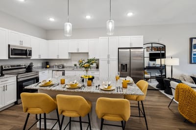 Modern kitchen interior with dining setup.