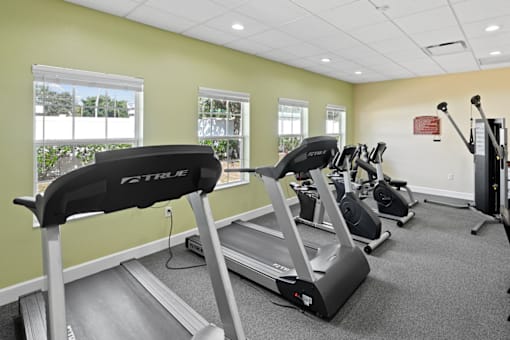 Fitness room with treadmills and workout equipment.