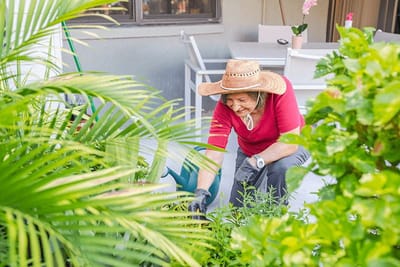 Resident gardening in a vibrant outdoor area