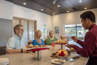 Residents enjoying a meal at the dining area.