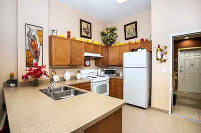 Bright kitchen interior with appliances and decor.