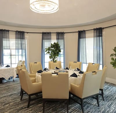 Elegant dining room with round table setup.