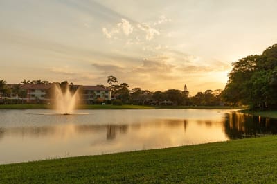 Beautiful sunset over a fountain in a serene lake