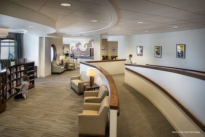 Interior view of a common area with seating and bookshelves.