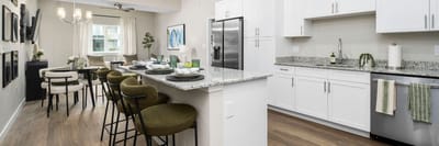 Modern kitchen and dining area in a senior living facility.