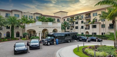 Facility entrance with shuttle and arriving vehicles