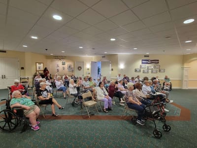 Residents seated together in a common area.