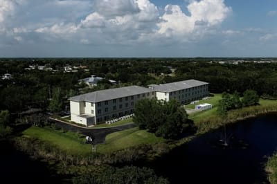 Aerial view of the facility by a pond