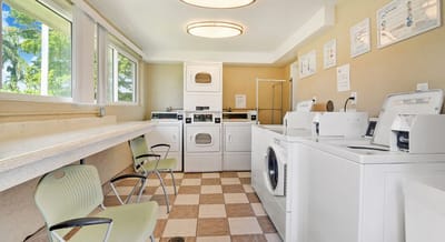 Laundry room with washing machines and seats