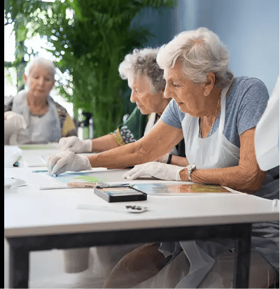 Residents engaging in an art activity indoors.