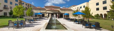 Outdoor area with seating and water feature.