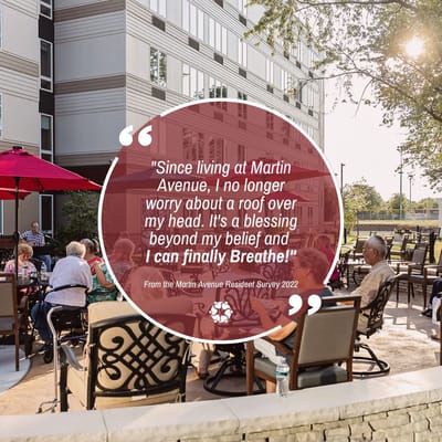 Residents enjoying the outdoor space with umbrellas and seating.