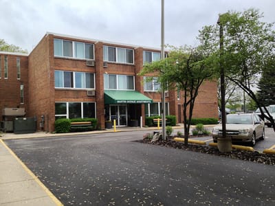 Exterior view of Martin Avenue Apartments with landscaping.