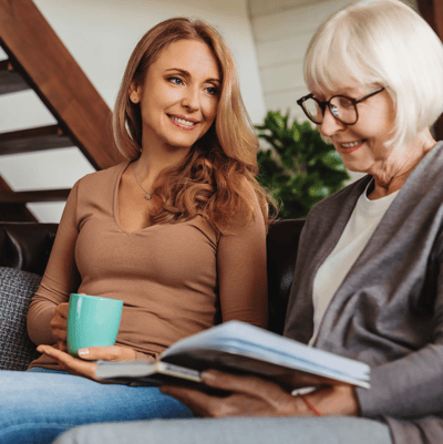 Two women engaged in conversation indoors.