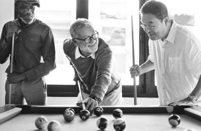 Residents enjoying a game of billiards indoors.