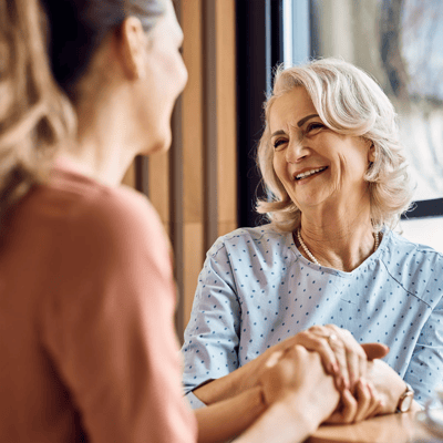 Resident and staff member enjoying a conversation.